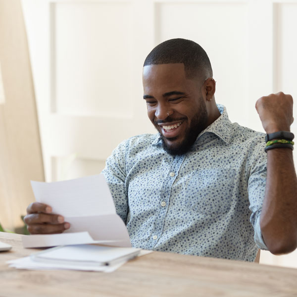 man excited looking at paperwork